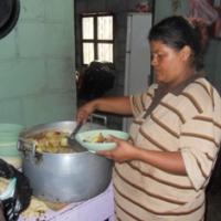 Una madre preparando los platos de alimentos para los ninos